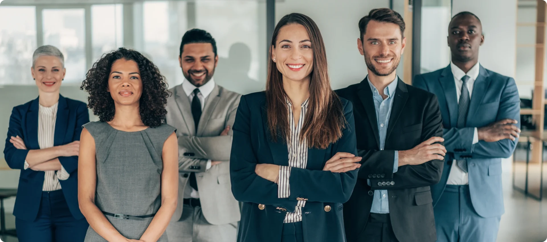 Diverse professionals posing together in suits