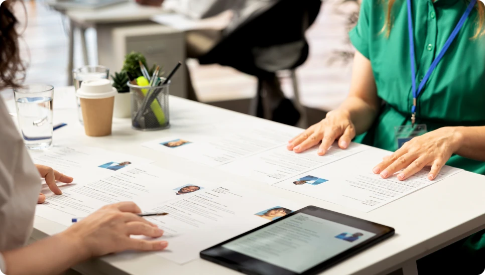 Interview process with documents and tablet visible