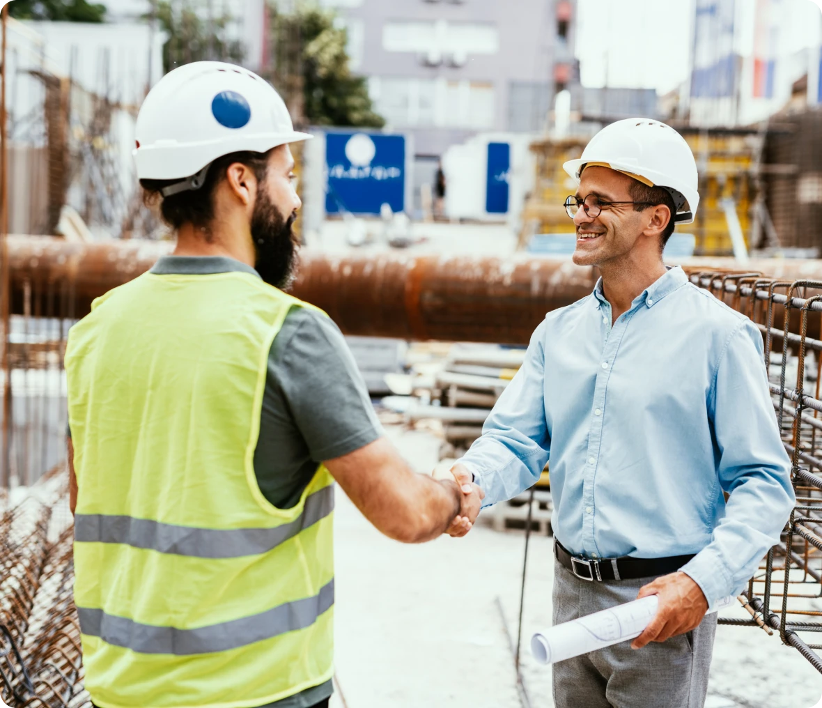 Engineers greeting with handshake outdoors