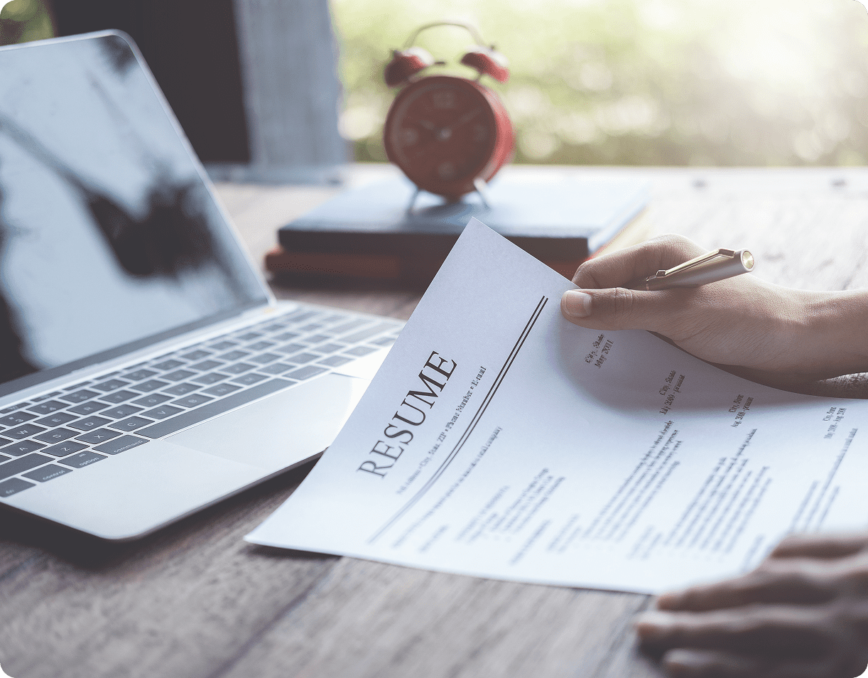 Job application preparation on wooden desk
